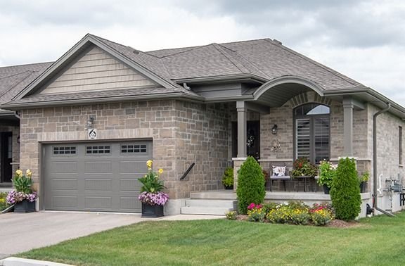 Stone home with covered porch and siding gables